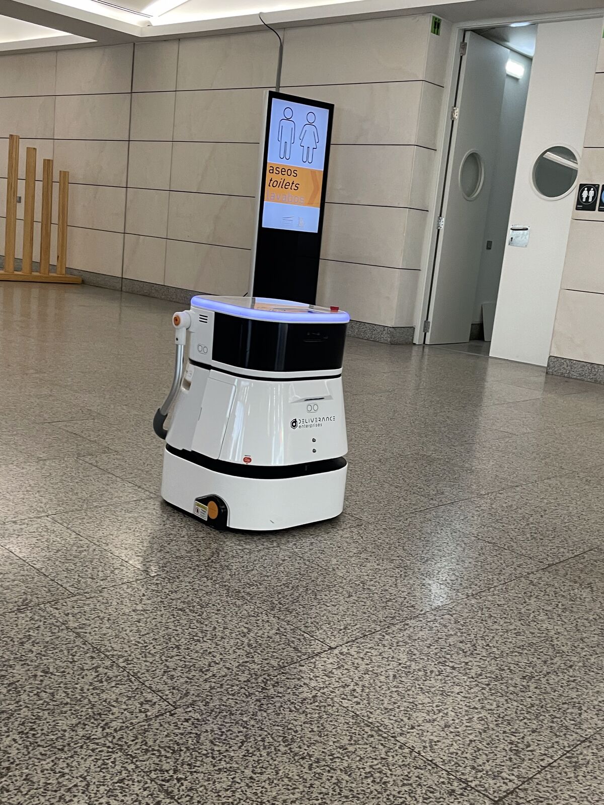 Cleaning robot beside the venue signage during the operational phase.