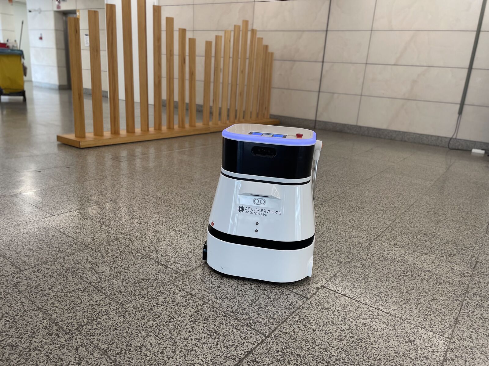 A Deliverance cleaning robot working the vestibule of the Palacio de Congresos de València